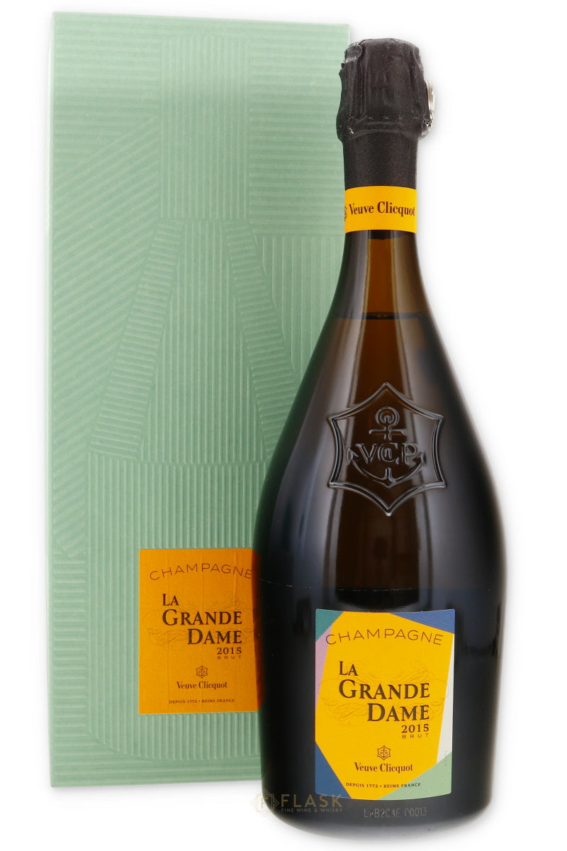 Bottle of Veuve Clicquot La Grande Dame champagne with a gift box in the background